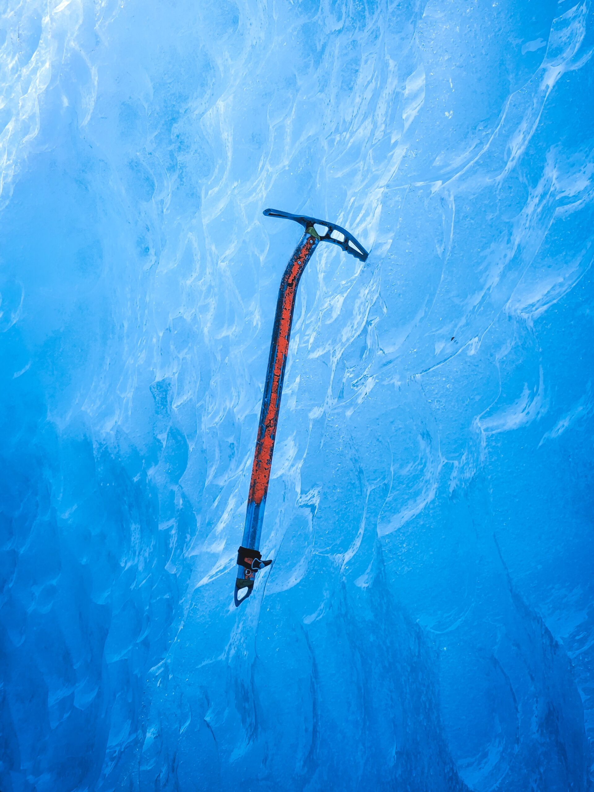 an ice axe on an ice all without a person